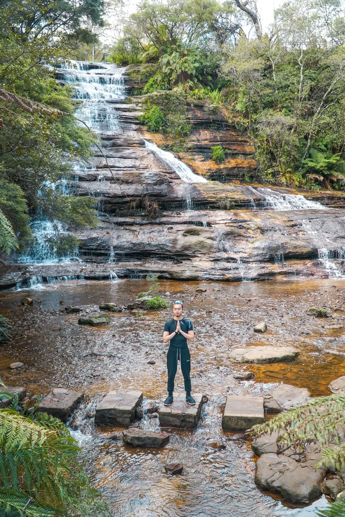 Freeman Fung, standing, hands in prayer position, at Katoomba Blue Mountains