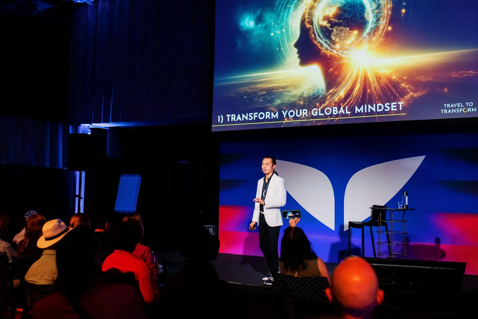 Freeman Fung on stage beside a screen reading 