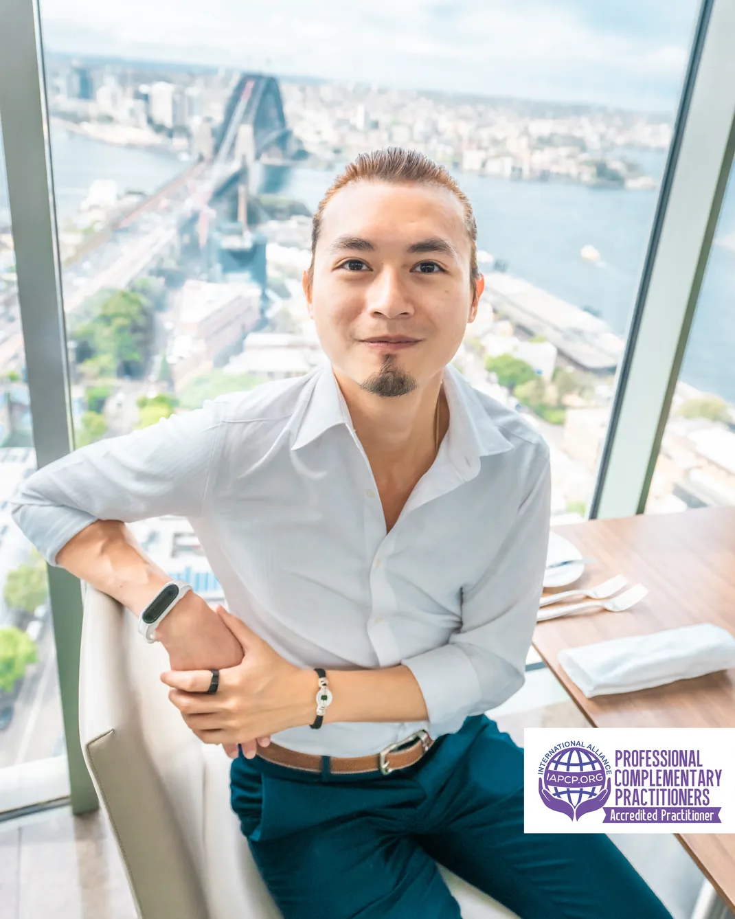 Freeman Fung Business Headshot with IACPC logo Sydney Harbour Views