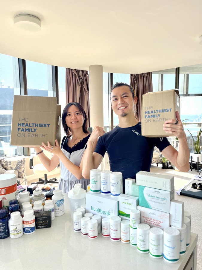 Freeman Fung and partner holding USANA Healthiest Family on Earth boxes